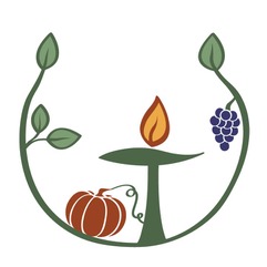 A lit chalice surrounded by vines with a pumpkin and a bunch of grapes.