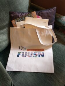 A tote bag with a logo that reads "175 Anniversary 1848-2023 FUUSN." The letters in "FUUSN" are filled with an image of the many members of the community standing in front of the church.
